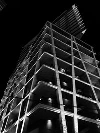 Low angle view of modern building against sky at night