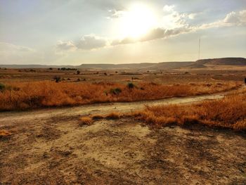 Scenic view of land against sky during sunset