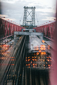 Blurred motion of illuminated bridge against sky