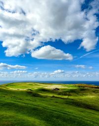 Countryside landscape against cloudy sky