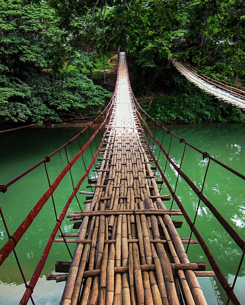 VIEW OF SUSPENSION BRIDGE IN WATER