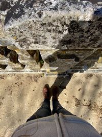 Low section of woman standing on a rock