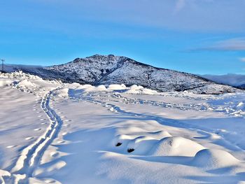 Scenic view of snowcapped mountains against sky