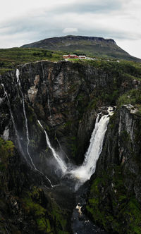 Scenic view of waterfall against sky