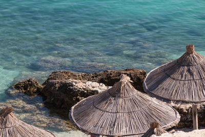 High angle view of parasol on shore by sea