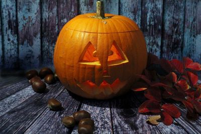 Close-up of illuminated jack-o-lantern on wooden table