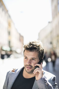 Portrait of young man using smart phone outdoors