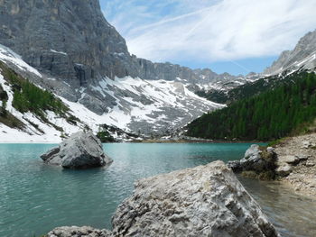 Scenic view of lake and mountains against sky