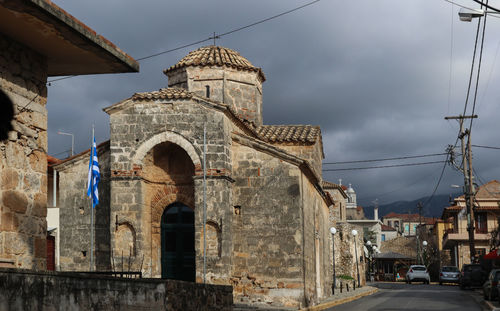 Low angle view of old building against sky in city