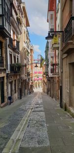 Narrow alley amidst buildings in city