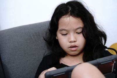 Close-up of girl using digital tablet