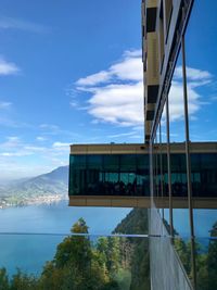 Built structure by lake against sky