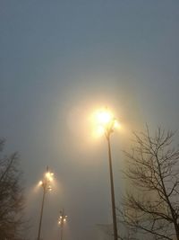 Low angle view of illuminated street light against sky during sunset