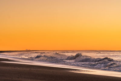 Scenic view of sea against clear sky during sunset