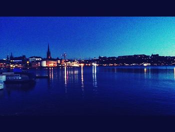 Reflection of illuminated buildings in water at night