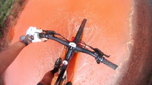 Close-up of man riding bicycle on road