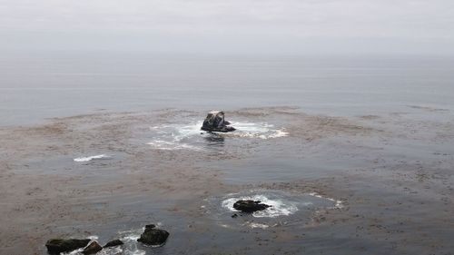 High angle view of rock formations in sea