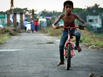 Portrait of man riding bicycle on road