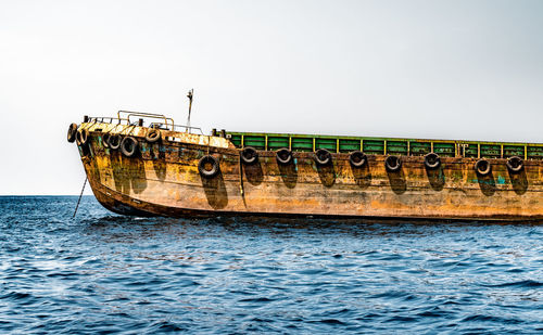 View of ship in sea against clear sky