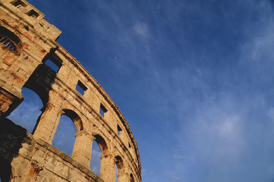 Low angle view of historical building against blue sky