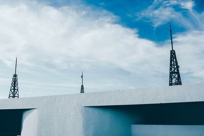 View of communications tower against cloudy sky