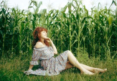 Woman sitting on field 