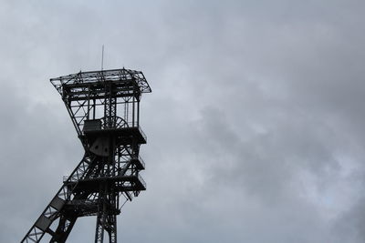 Low angle view of metallic tower against sky