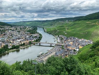 High angle view of river amidst city against sky