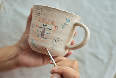 Close-up of hand holding coffee