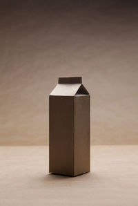 Close-up of empty box on table against wall