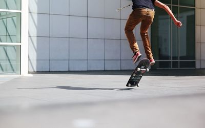 Low section of man skateboarding on skateboard