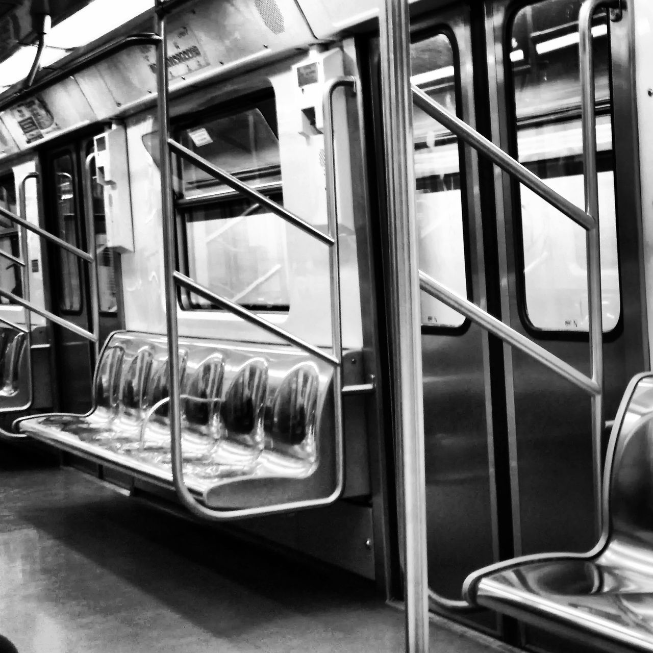 indoors, transportation, window, glass - material, mode of transport, transparent, vehicle interior, public transportation, metal, in a row, reflection, absence, no people, train - vehicle, vehicle seat, empty, day, seat, passenger train, train