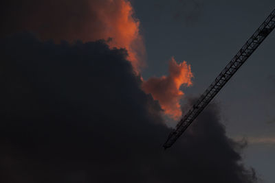 Low angle view of smoke emitting from chimney against sky