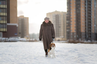 Woman with dog on snow