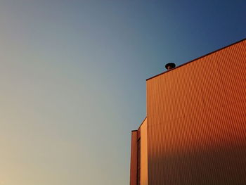 Low angle view of building against sky during sunset