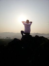 Woman with umbrella against clear sky