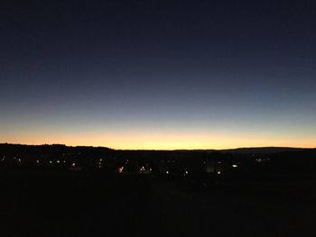 View of illuminated mountains against clear sky