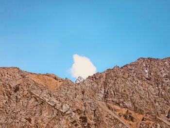 Low angle view of mountain against blue sky