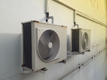 Low angle view of electric fan on wall