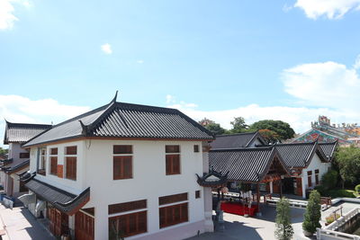 Houses in town against sky during winter