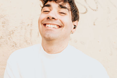 Portrait of young man against yellow wall