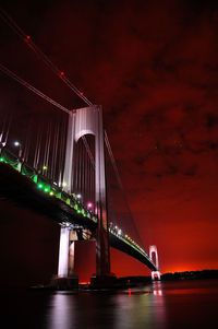 Low angle view of suspension bridge at night