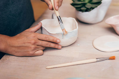 Midsection of person preparing food on table