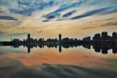 Scenic view of silhouette buildings against sky during sunset
