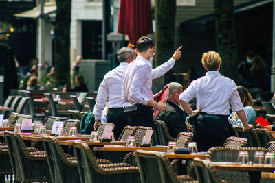 Rear view of people standing at market