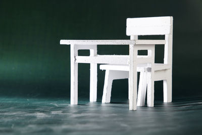 Figurine of chair and table on blackboard