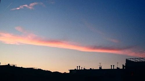 Silhouette of built structure at sunset