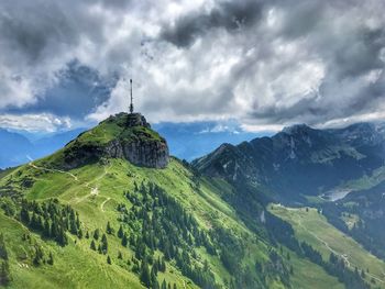 Scenic view of mountain range against cloudy sky