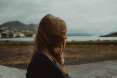 Rear view of a woman against sea