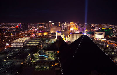 High angle view of illuminated buildings in city at night